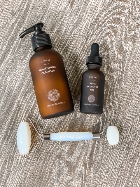 True Botanicals Renew Nourishing Cleanser, Renew Pure Radiance Oil, and moonstone Radiance Facial Roller.